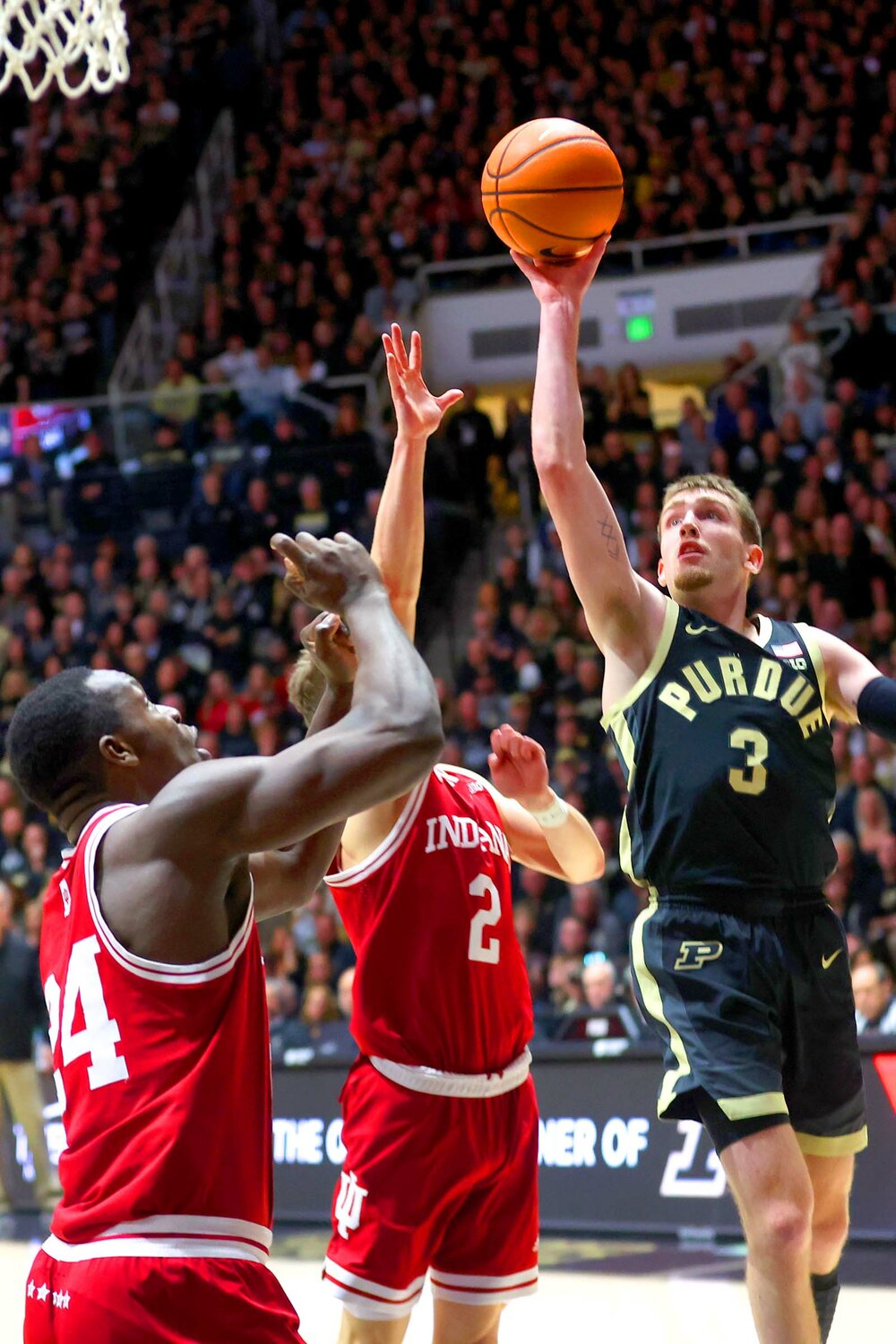 Braden Smith of Purdue - shooting a lay-up over Gabe Cupps (2) and Payton Sparks of Indiana