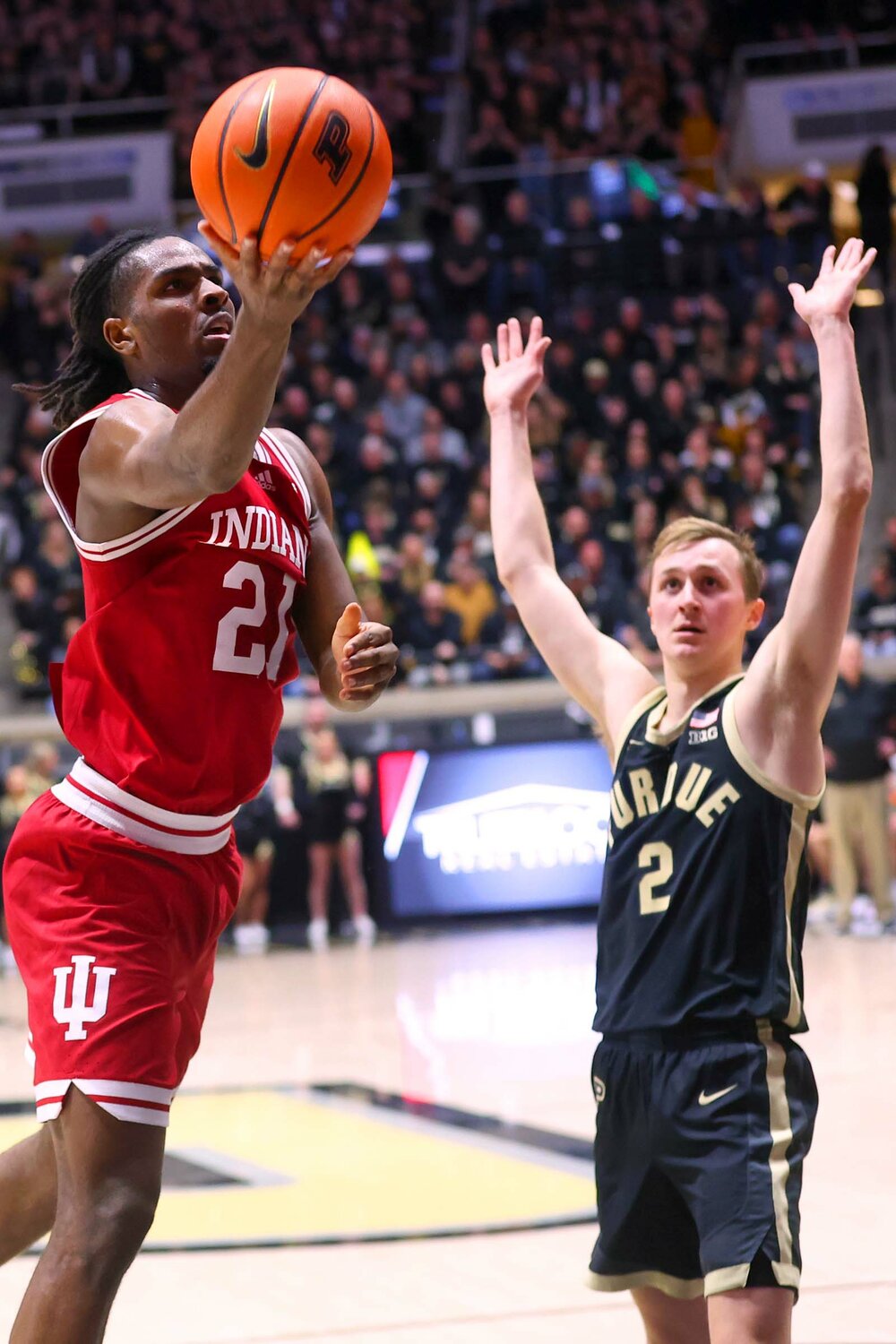 Mackenzie Mgbako of Indiana - scooping a lay-up late in the game as Fletcher Loyer of Purdue gets out of the way