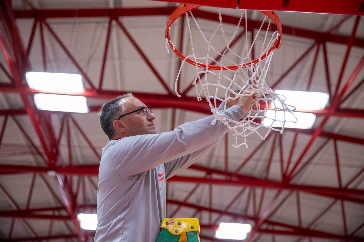 Wabash head coach Kyle Brumett cuts down the nets at Chadwick court as his Wabash College Little Giants secured the North Coast Athletic Conference regular season title with a 91-81 win over Wooster. The win for Brumett was also his 300th career win.