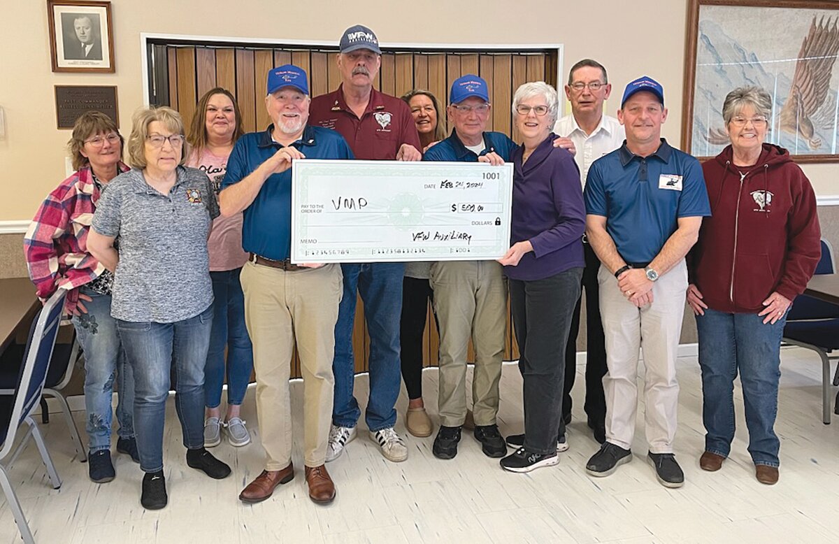 The Auxiliary at VFW Post 1431 made a $500 donation Saturday to the Veterans Memorial Park. Pictured, from left, are Patricia Hill, Kathy Conkright, Leah Denbo, Mike Spencer, Tex Kersey, Julie Conkright, Sharon Zlotucha, Marc Gabel, John Douglas and Kathy Billingsley.