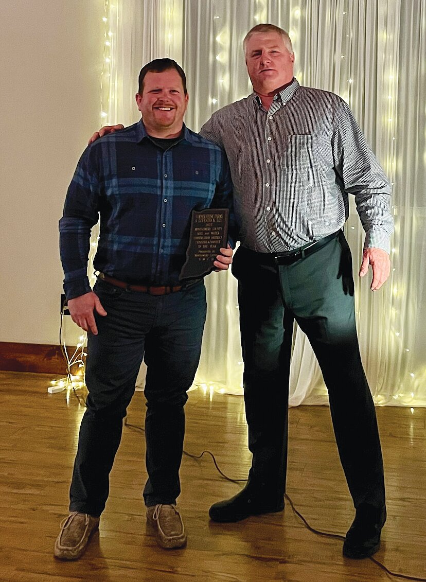 Jarrod Zachary, left, accepted the Conservationist of the Year Award for Cornerstone Farms and Livestock. Also pictured is Dave Stanley, district conservationist.