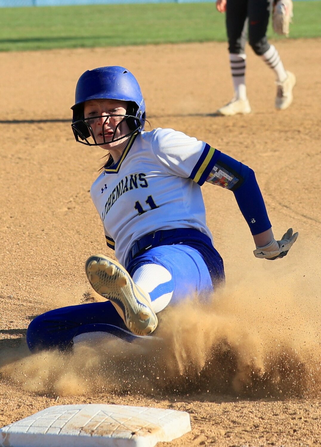 Sophomore Olivia Hedrick slides into third base