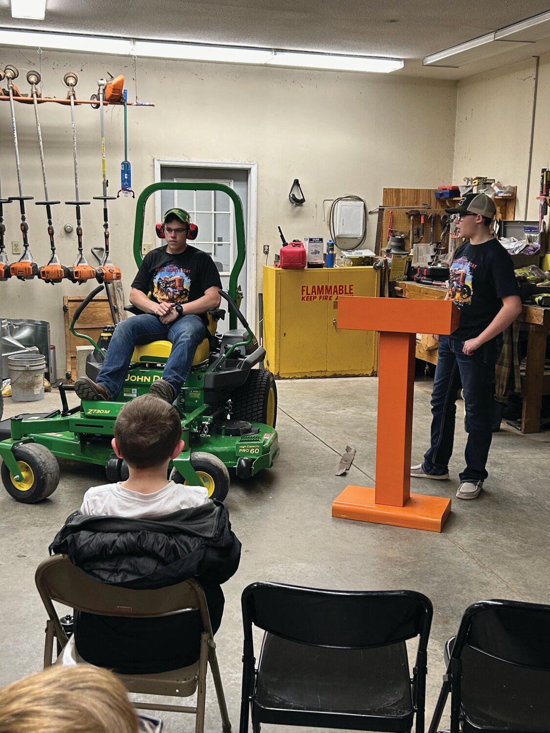 FFA members Israel Rose (left) and Adam Riehle (right) instruct students on motor safety.