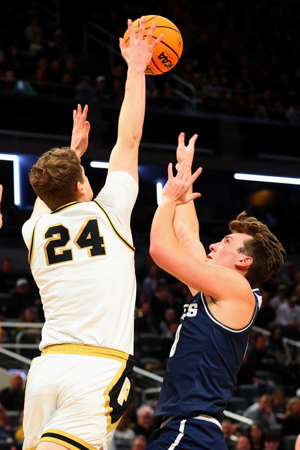 Sam King of Purdue - going for a block on Landon Brenchley of  Utah State.