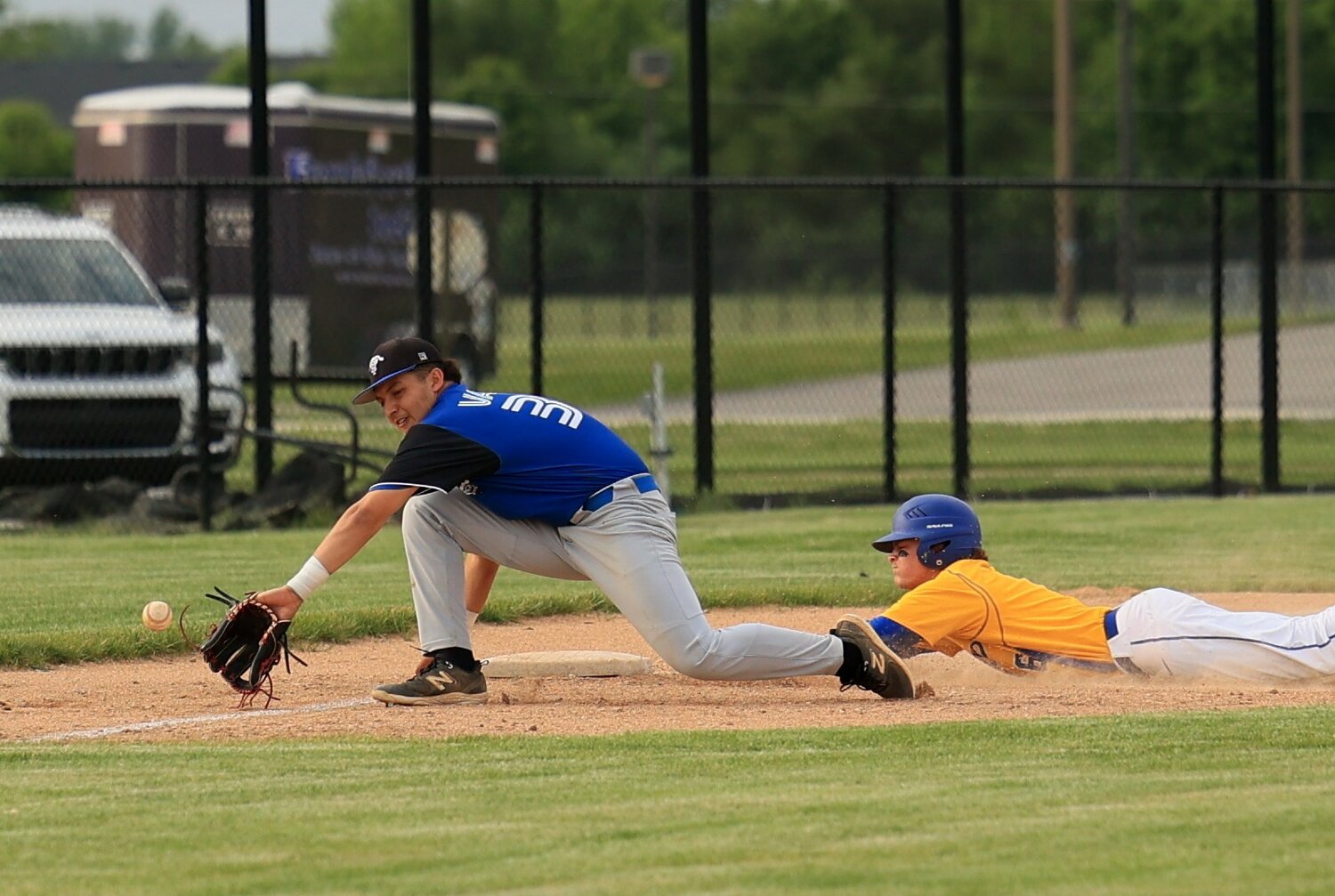 Jude Coursey slides into third during the Athenian win.