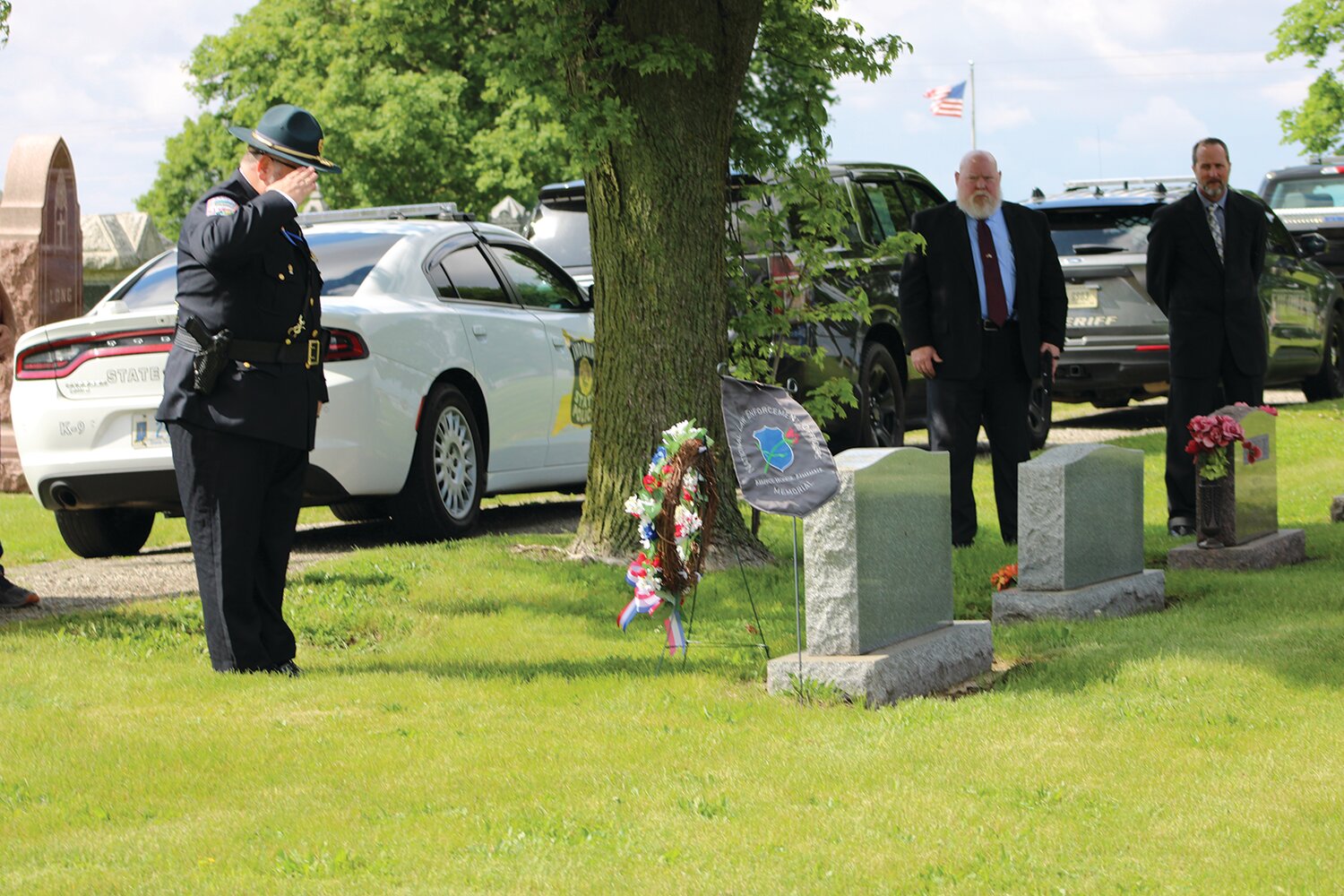 Aaron Clapp salutes at his father's grave.
