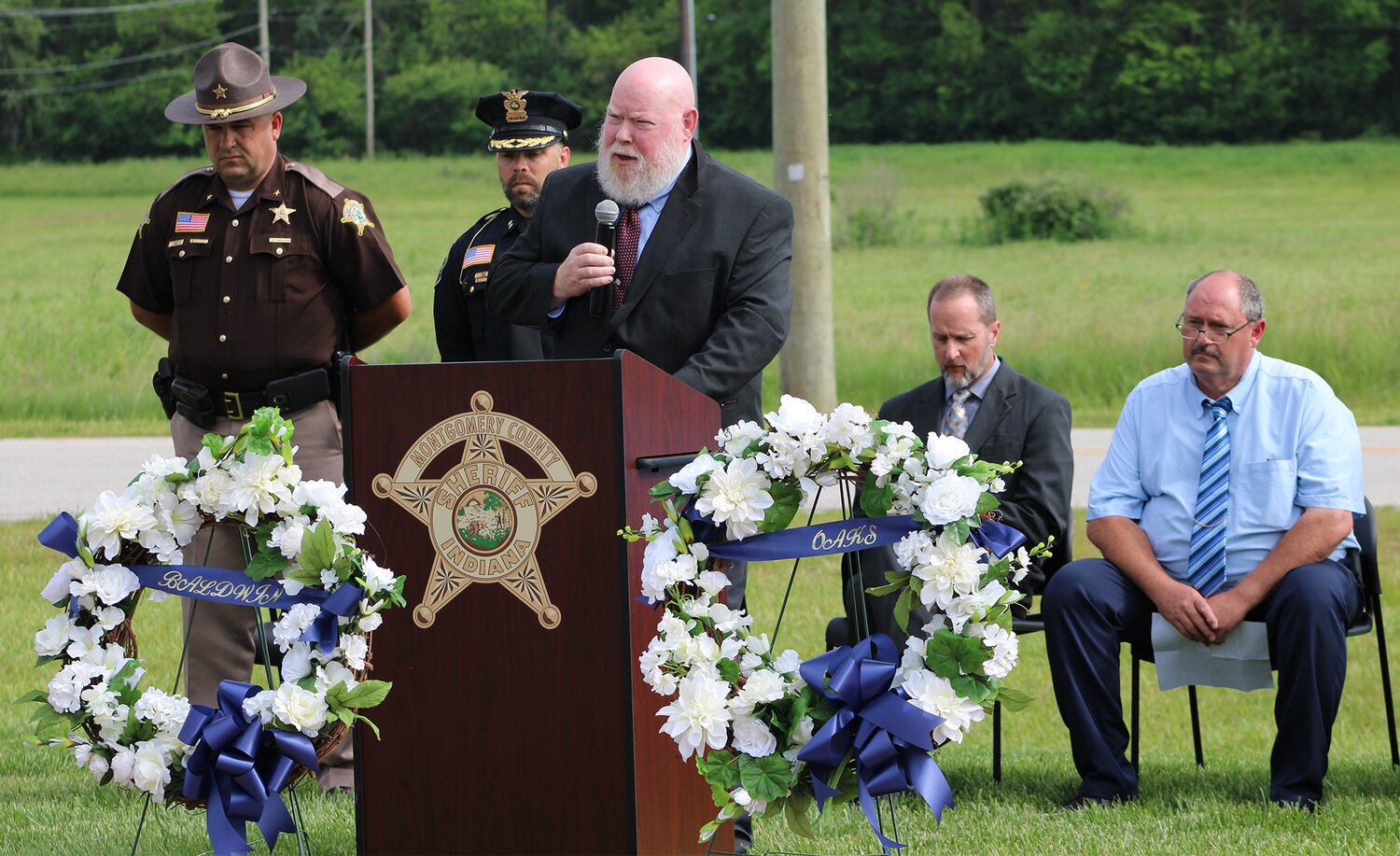 CPD Chaplain Alan Goff welcomes the crowd who gathered for the Police Week Memorial ceremony on Wednesday.