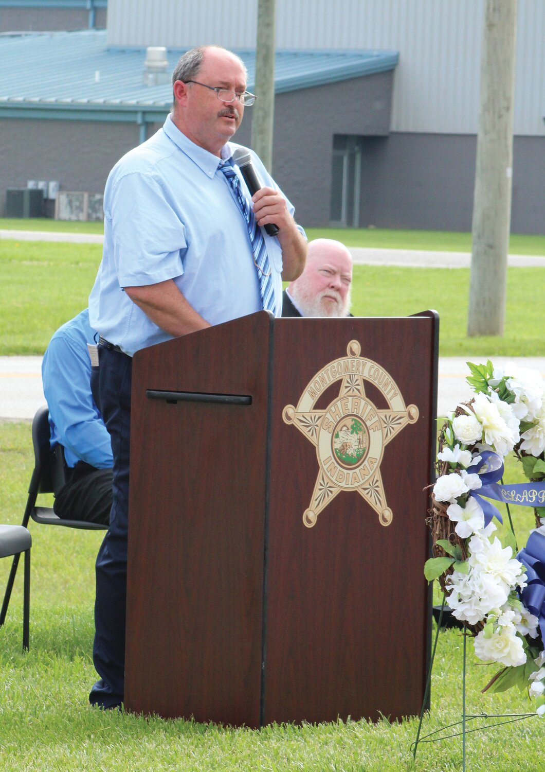 Henry Carroll, representing Lt. Russell Baldwin's family, addresses the crowd.