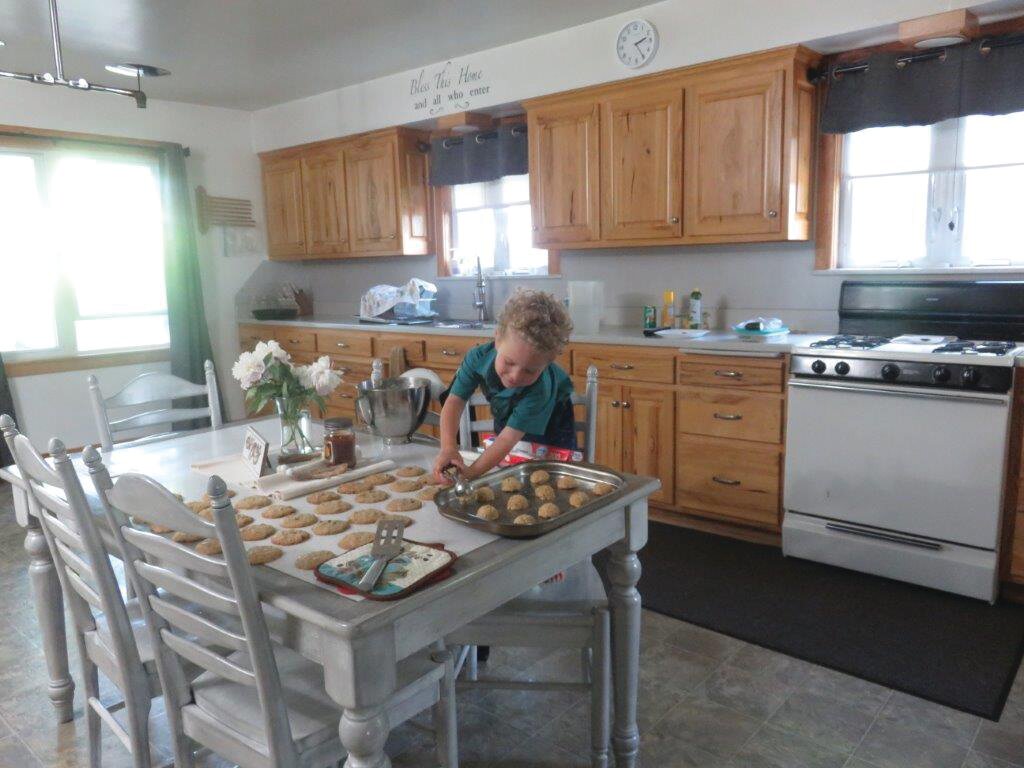 Joshua helping to bake cookies in the kitchen.