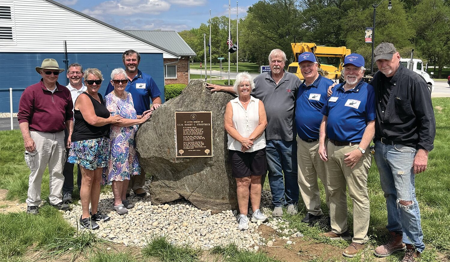 An eight-ton rock with a plaque honoring the memory of World War II and Vietnam War Veteran Robert Strodtbeck was recently installed at Veterans Memorial Park by VMP Advisor Roy Hurt of Craw-Con Inc. and Gail Blackwell of B&L Engineering, who have contributed $10,000 to date through in-kind contributions to the park. It had been on display at a private residence in Greencastle. It was donated by Valerie Abernathy, Geraldine Payne and Linda Larkin, friends of Strodtbeck’s daughter Helen. Pictured are VMP board secretary Bill Durbin, VMP board member John Douglas, donors Valerie Abernathy and Geraldine Pain, VMP board president Kevin Cobb, donor Linda Larkin, equipment operator Gail Blackwell, VMP board advisor Mark Eutsler, VMP board vice president Mike Spencer and VMP advisor Roy Hurt. VMP is organized as a not-for-profit corporation and is recognized as tax-exempt by the IRS under Section 501(c)(3). Its mission is “Honoring All Veterans.” Various parts of the park and its operation are available for sponsorship and underwriting, including purchasing bricks that will surround the center monument. Engraved bricks will recognize veterans and those who support veterans. More information is available on the park’s Facebook page — Veterans Memorial Park – Crawfordsville.