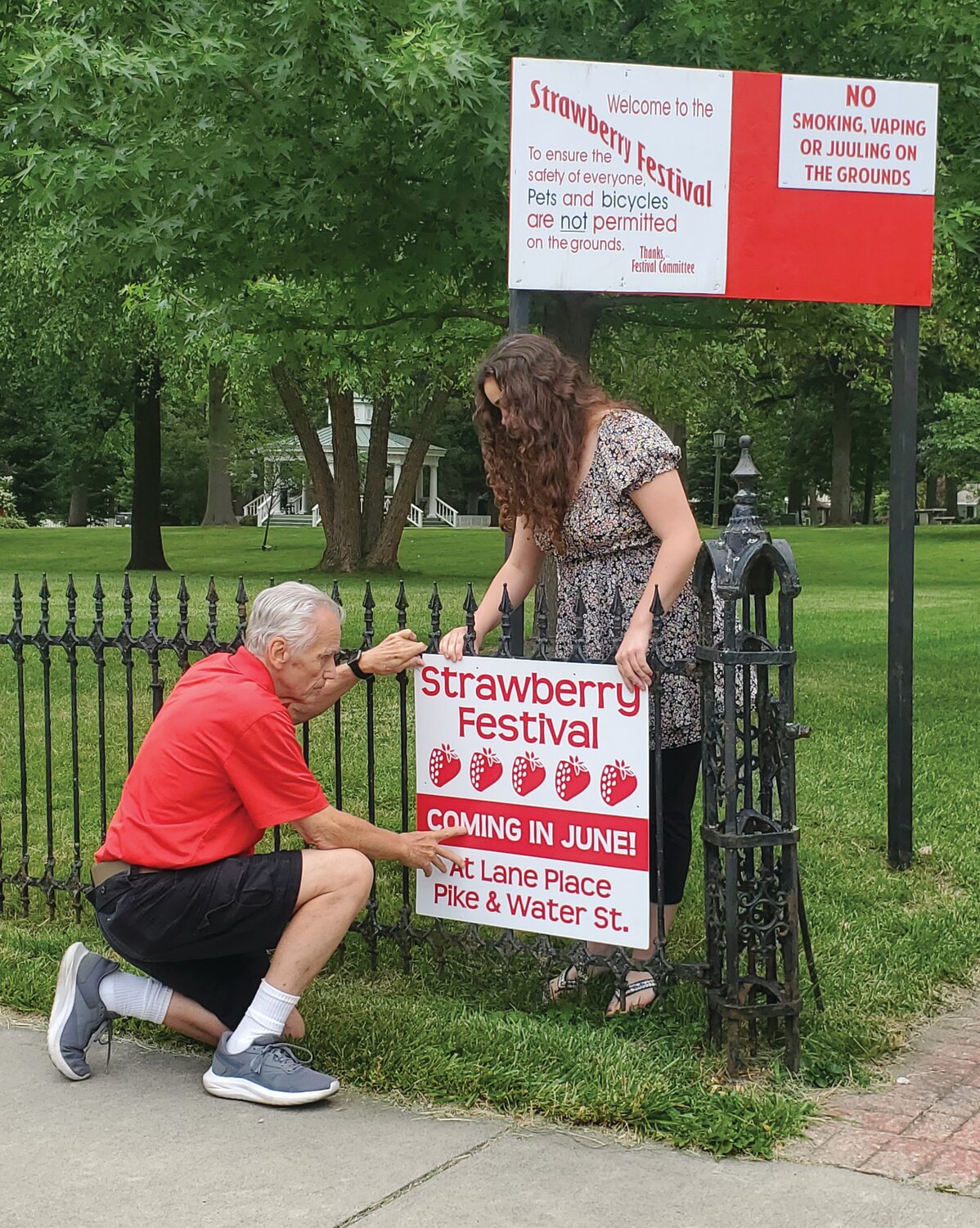 Sierra Hutchison and Chairman S. David Long place the final signs on the Lane Place fence prior to the upcoming 50th anniversary of the Crawfordsville Strawberry Festival. Activities begin Friday and continue through Sunday at Lane Place at Pike and Water streets. There will be live music, food and craft vendors, children’s games, car and tractor shows, a 5k walk/run as well as softball and tennis tournaments throughout three-day event. To learn more, visit online at https://crawfordsville
strawberryfest.com/.