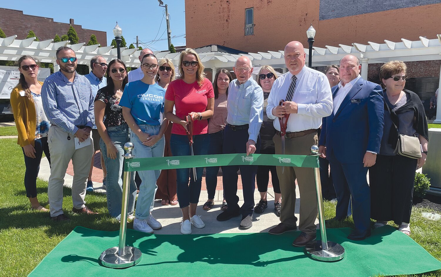 Donors gather Wednesday to cut the ceremonial ribbon at the new Crawford Fountain located in the Marie Canine Plaza at Main and Green streets.