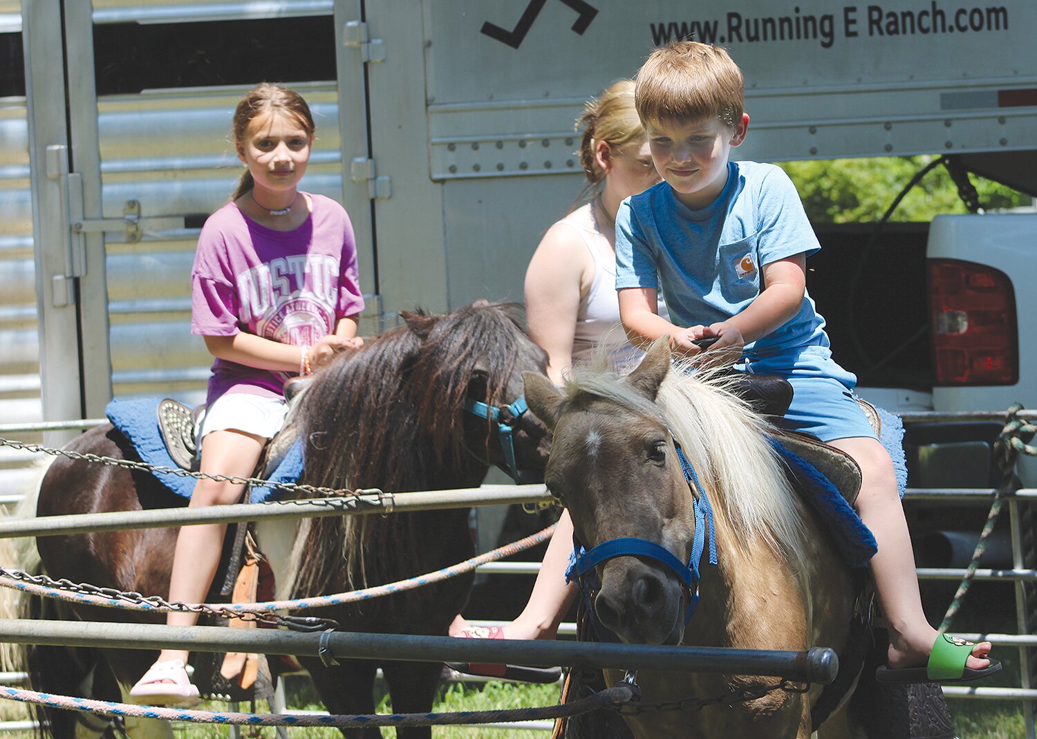 Case Evans, 6, and Ellie Evans, 9, ride the ponies Friday at the 50th annual Crawfordsville Strawberry Festival.