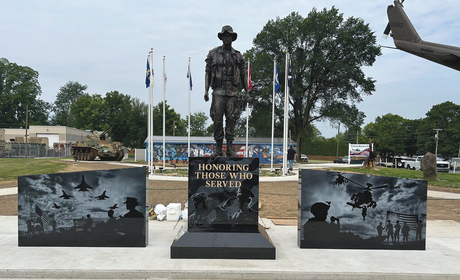 A new centerpiece was installed Wednesday at Veterans Memorial Park on South Washington Street. The nearly 11-foot-tall statue and 23-foot-wide monument was donated by Allen Monument Company and installed by BNL Engineering. The statue depicts a Vietnam era soldier that is flanked by two jet black granite panels. Each panel contains laser-etched military scenes. The center granite piece is inscribed with the words, “Honoring Those Who Served.”
