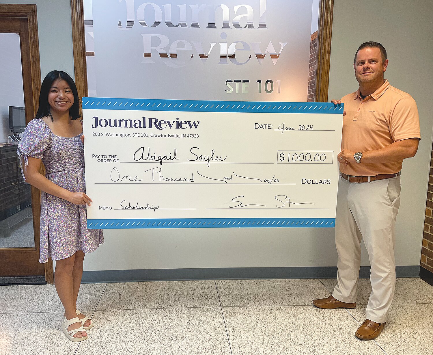Abigail Sayler, left, also was selected as a 2024 Journal Review Scholar and was presented with a $1,000 check from Storie.