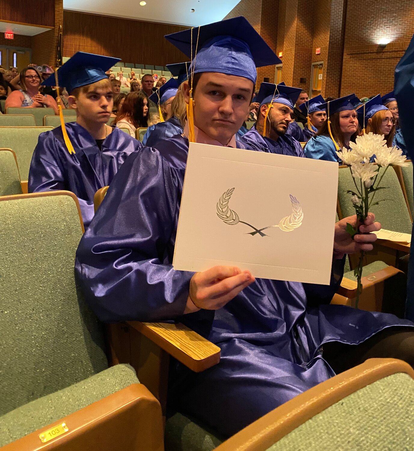 Caleb Abney shows off his diploma.