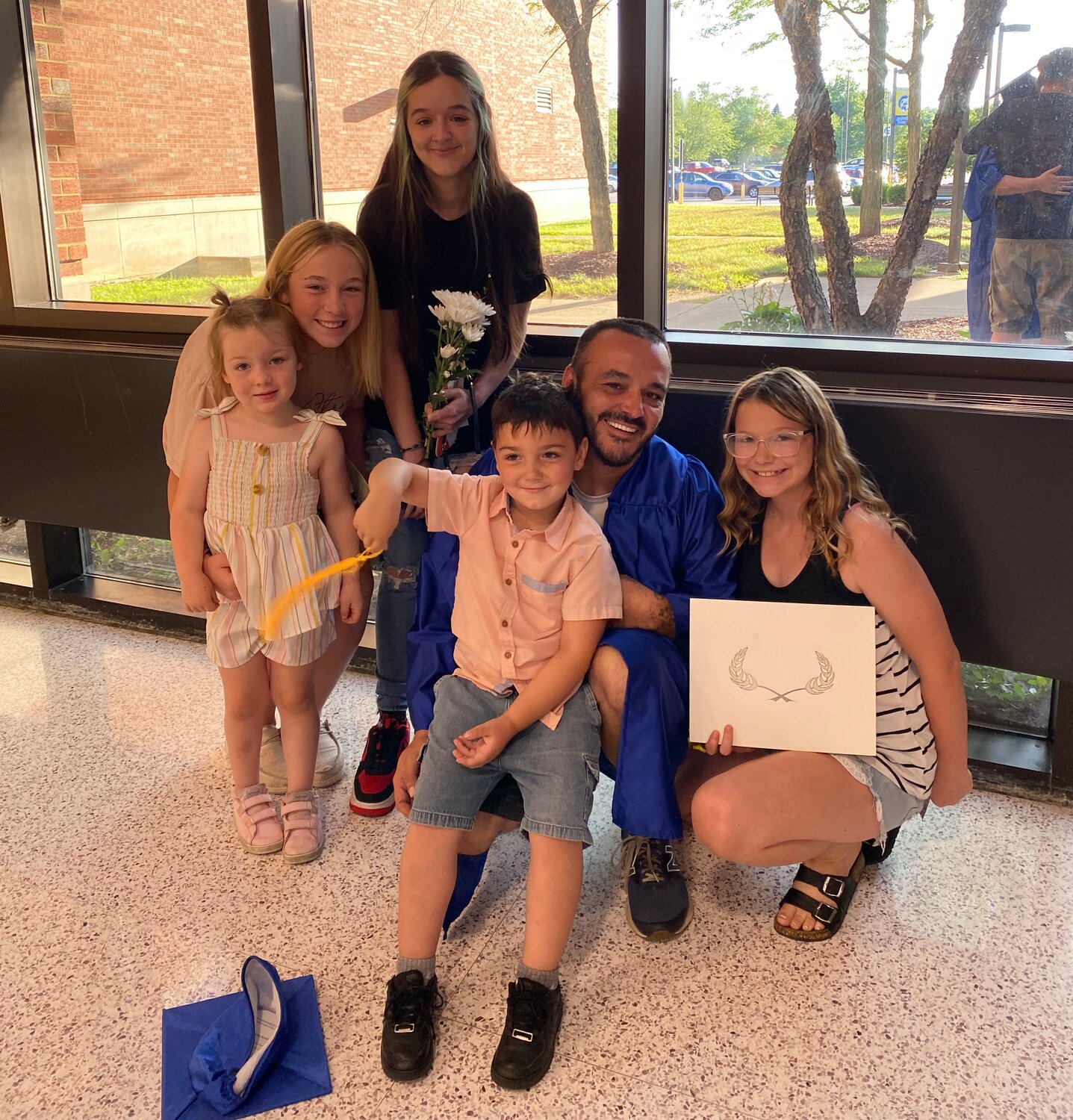 Keith Hutson poses with family after commencement exercises.