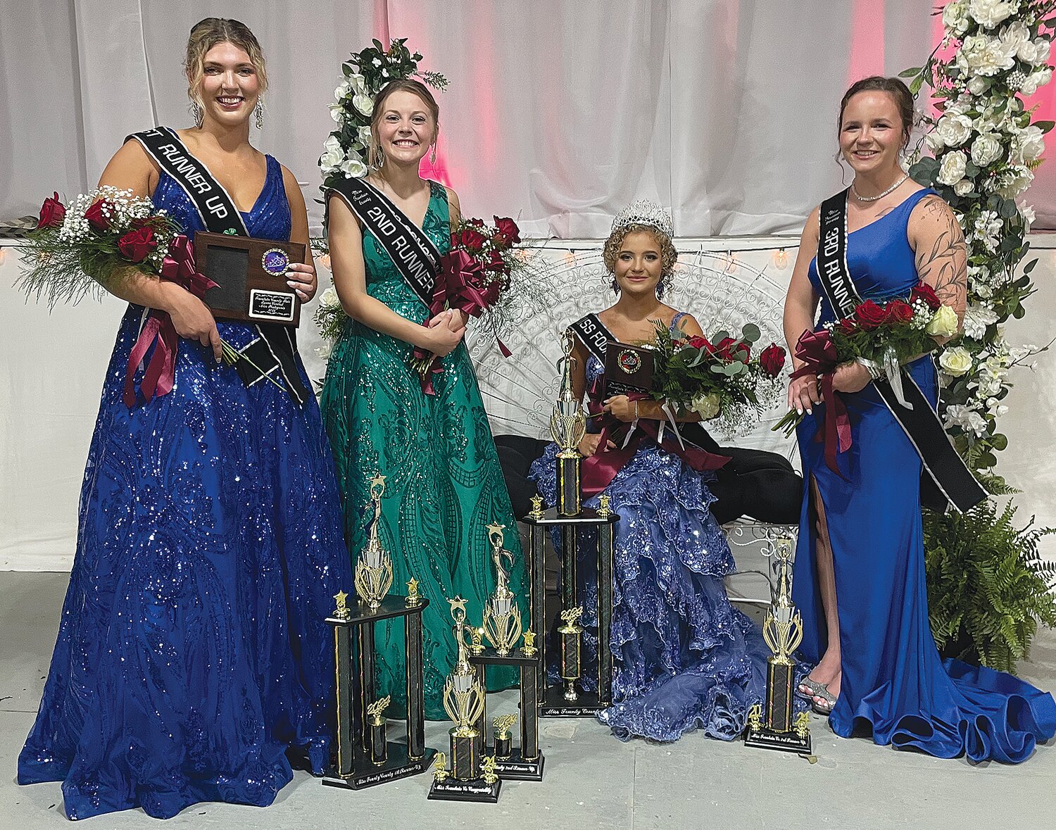 Alexis Myers (seated) was crowned Miss Fountain County 2024 on Saturday. She also earned the People’s Choice Award. Myers is pictured with member of her court, from left, Micah Stonecipher, first runner-up and winner of the photogenic award; Avery Donaldson, second runner-up and Miss Congeniality; and Ashlynn Livengood, third runner-up. The Fountain County 4-H Fair continues through Thursday at Veedersburg.
