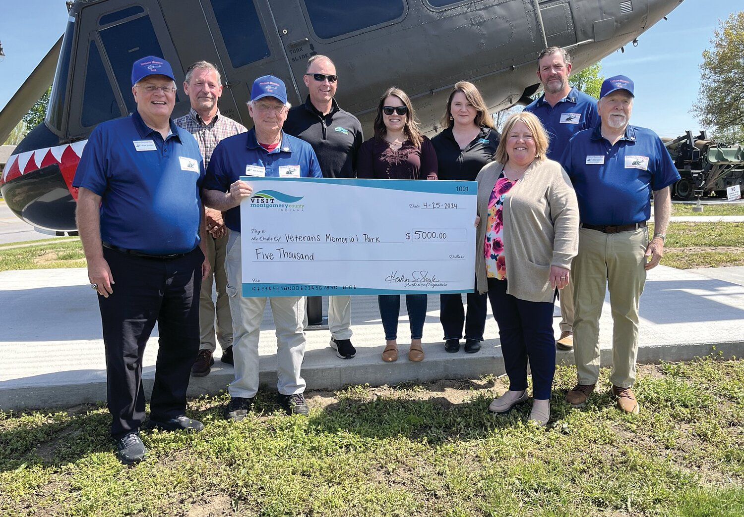 Veterans Memorial Park Board Members Mark Eutsler and John Douglas, Montgomery County Visitors and Convention Bureau Board Members Darren Hass, Casey Hockersmith and Jessica Harris, MCVCB Executive Director Heather Shirk, VMP President Kevin Cobb, and VMP Vice President Mike Spencer celebrate the bureau’s $5,000 grant for the fabrication, installation and space lease in the Indiana Department of Transportation’s Tourist Oriented Directional Signs program. VMP signage will be installed near Interstate 74 Crawfordsville exit ramps later this year. VMP is organized as a not-for-profit corporation and is recognized as tax-exempt by the IRS under Section 501(c)(3). Its mission is “Honoring All Veterans.” Various parts of the park and its operation are available for sponsorship and underwriting, including purchasing bricks surrounding the center monument. Engraved bricks will recognize veterans and those who support veterans. More information is available on the park’s Facebook page — “Veterans Memorial Park – Crawfordsville.”