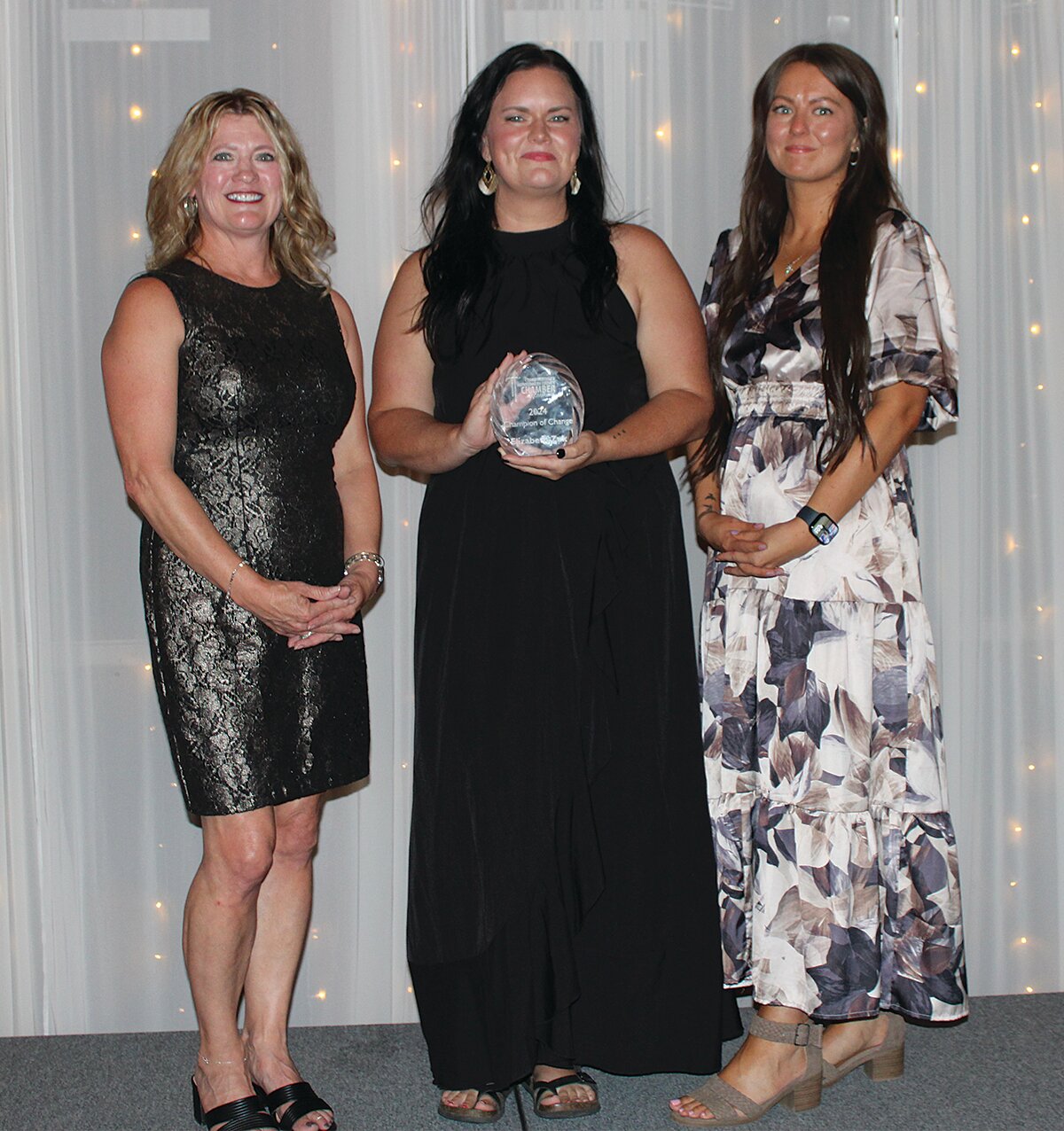 Elizabeth Zuk, center, was awarded the 2024 Champion of Change Award. She is pictured with Stacy Sommer, left, and KylLe Risner.