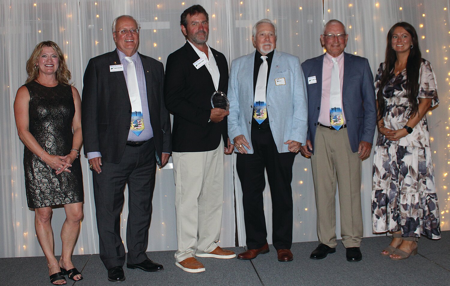 Board members for the Veterans Memorial Park, Mark Eutsler, second from left, Kevin Cobb, Mike Spencer and Bill Durbin, were awarded the 2024 Community Organization of the Year Award. They are pictured with Stacy Sommer, far left, and KyLee Risner, far right.