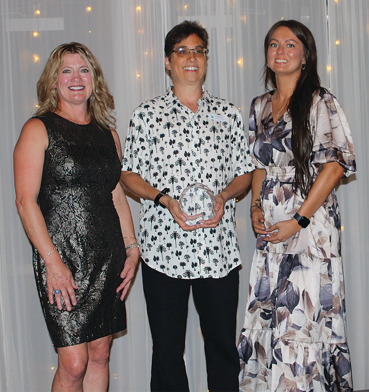 Jai Miranda, center, owner of Quest for Balance Wellness, won the 2024 Small Business of the Year Award. She is pictured with Stacy Sommer, left, and KyLee Risner, right.