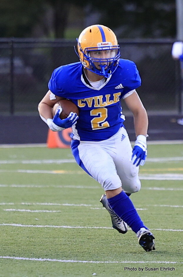 Sam Minnette carries the ball for the Athenians in the game against Western Boone on Friday.