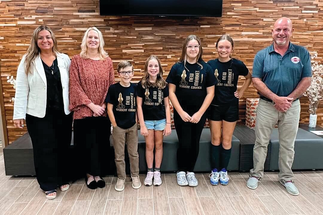 Superintendent Dr. Stephanie Hofer, left, and board president Daryl Hutson, right, pose with the New Market Elementary student council officers and sponsor Dana Hunt after the pledge of allegiance.