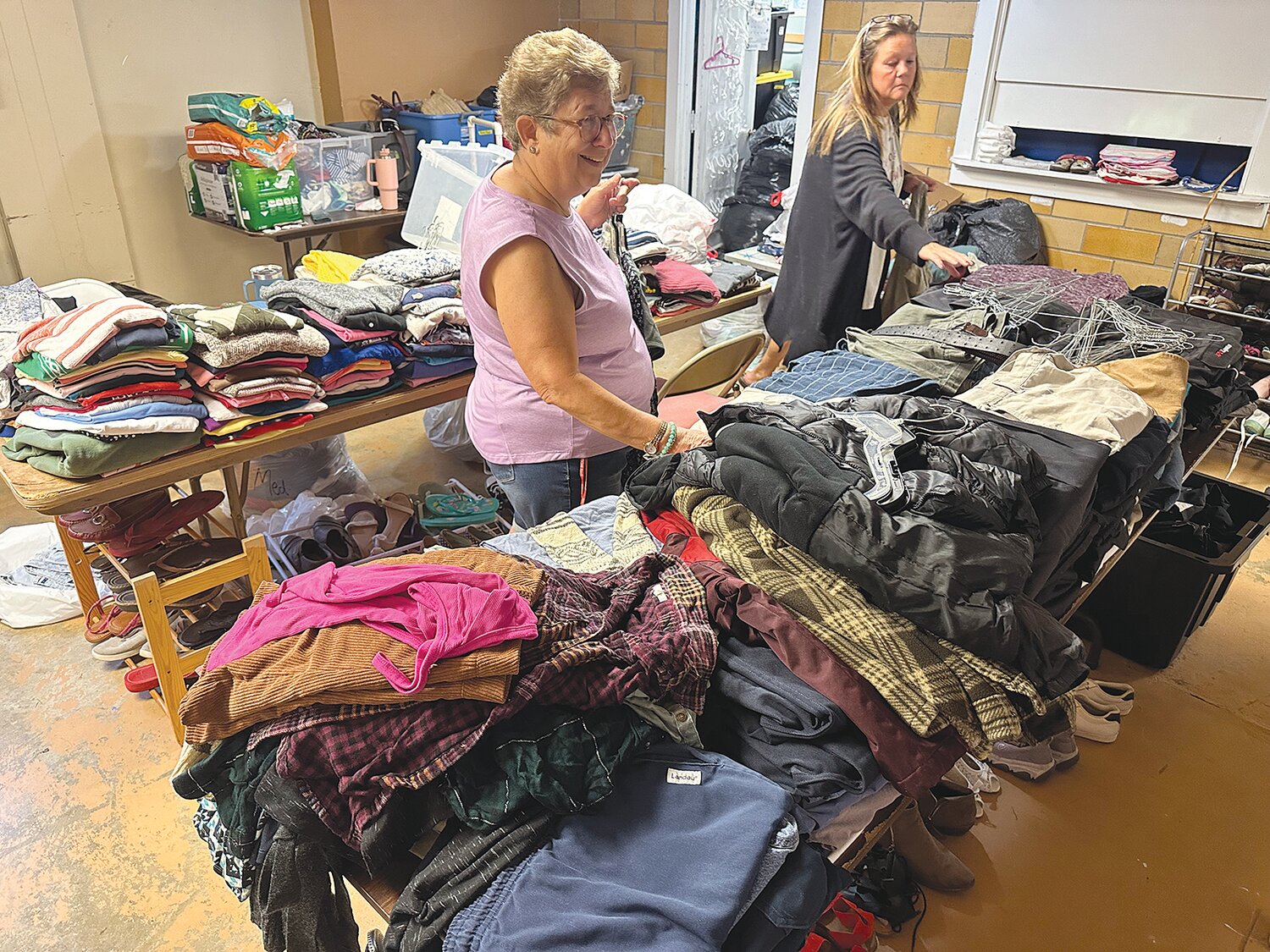 Melinda Rhoads, left, and Kari Haniford sort through the donations in preparation for Saturday’s distribution from 9 a.m. to noon at the New Market’s First Baptist Church. The church operates The Lord’s Closet. Organizers are seeking children’s coats and boots for winter. The items will be distributed free of charge at a later date.