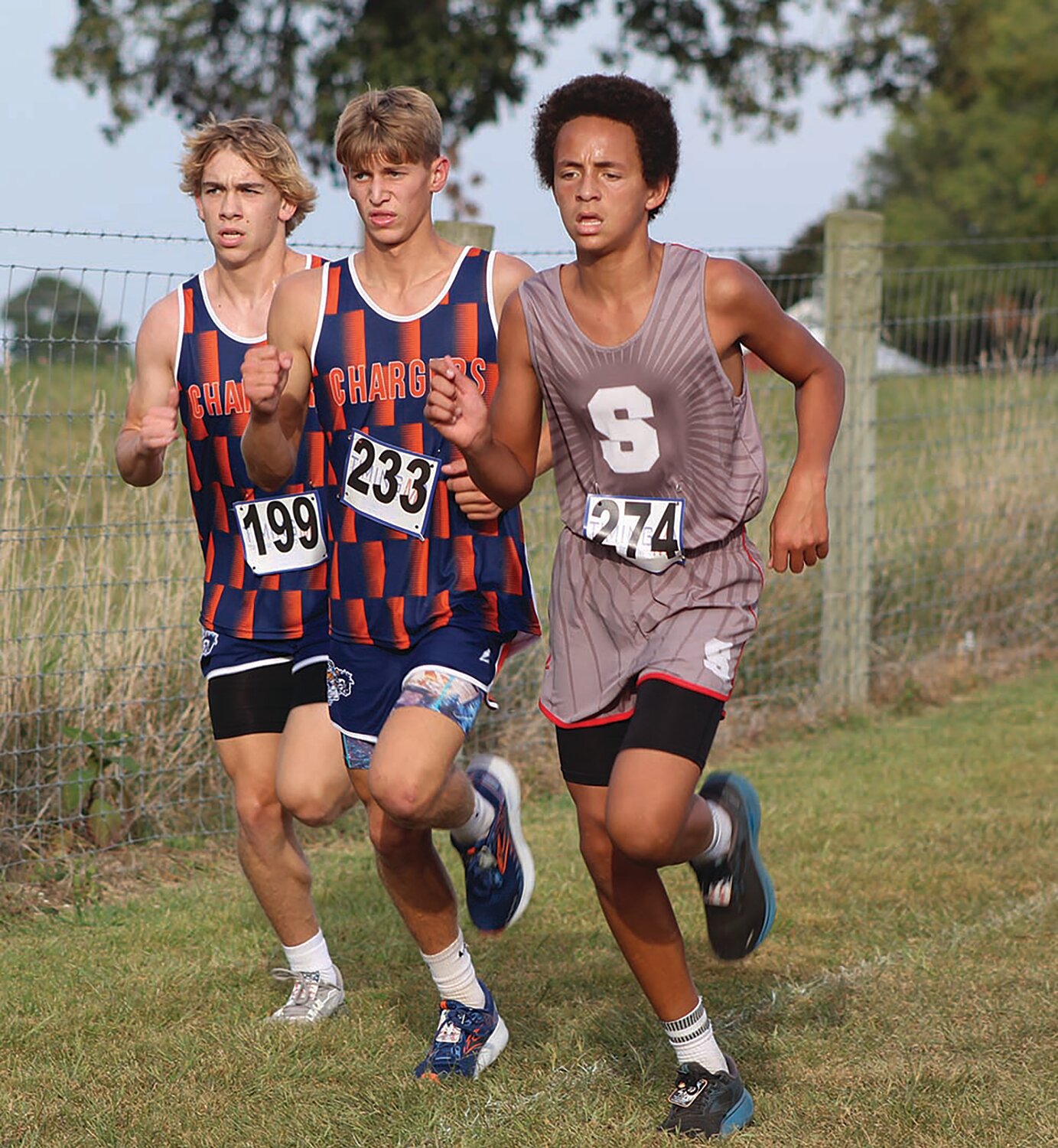 From left North Montgomery cross country runners Kale Mitchell, Blake Welch and Southmont's Jackson Fruits battle it out at Thursday's Charger Classic.