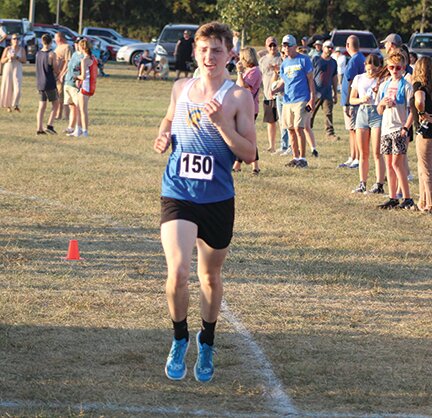 Hutton Haas crosses the finish line at Wednesday's Montgomery County Cross Country Meet. Haas led his teammates to the county team title.