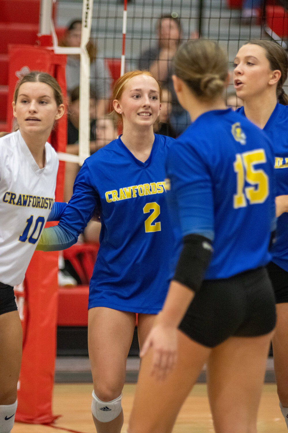 Crawfordsville's Emma Buser (10), Ally Strickland (2) and Claire Peacock (15) celebrate a point. The Athenians claimed the county championship on Tuesday.