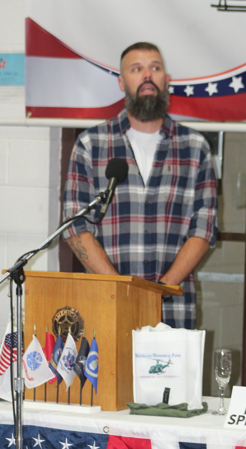 Veteran Kevin Barker performs the National Anthem.