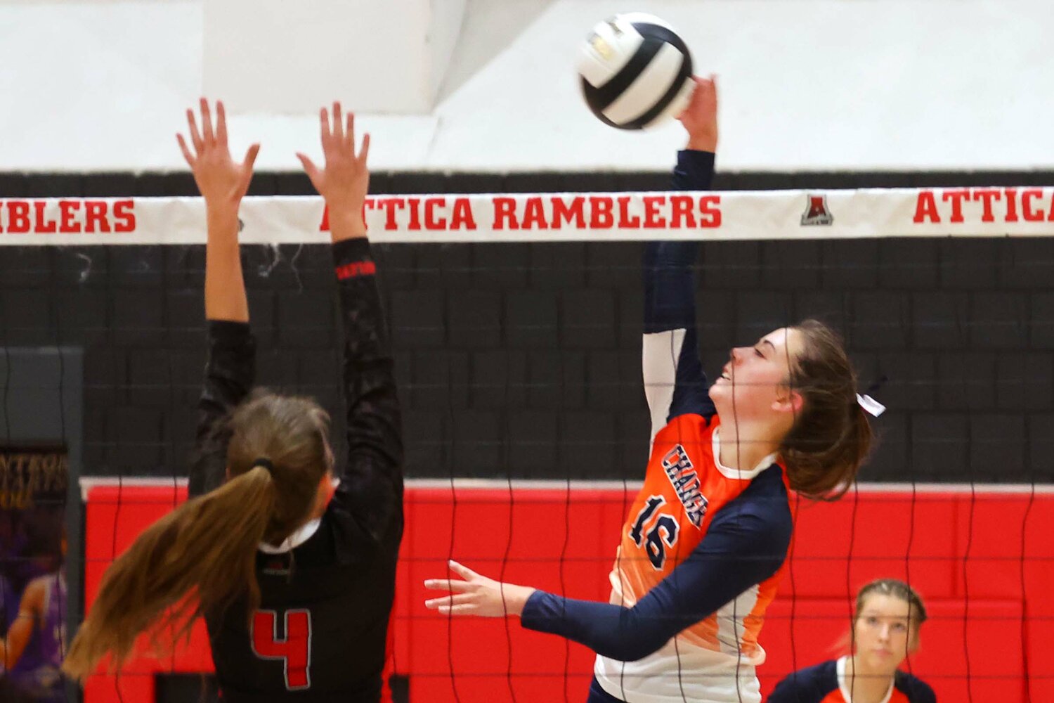 Hope Delp of North Montgomery hits over Aleah Cruz of Attica.