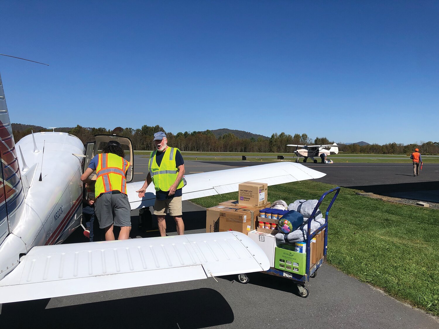 Two volunteers in North Carolina unload one of the aircrafts sent with donations on Oct. 9.