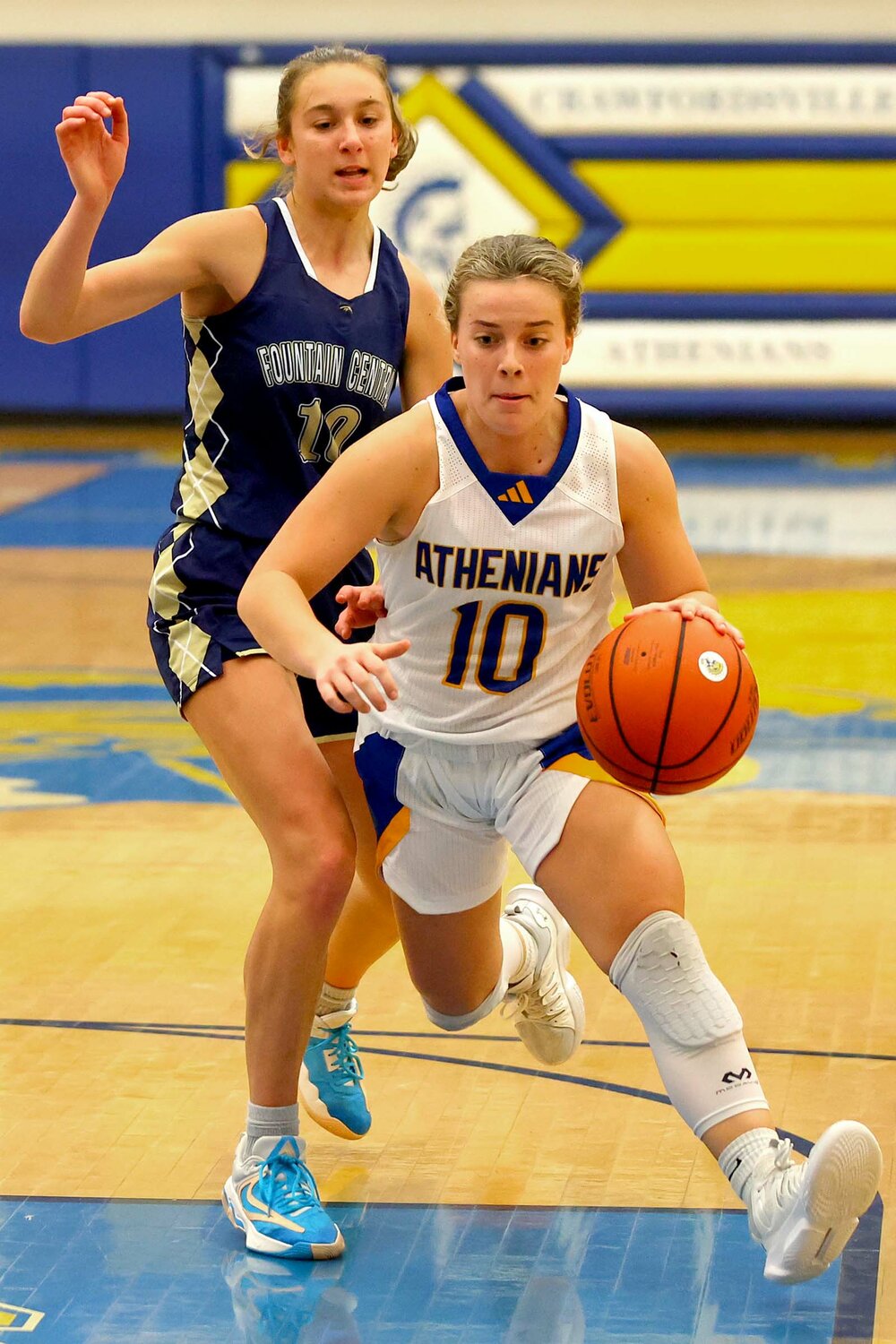 Molly Pierce of Crawfordsville drives the lane after getting past Brailey Hoagland of Fountain Central.