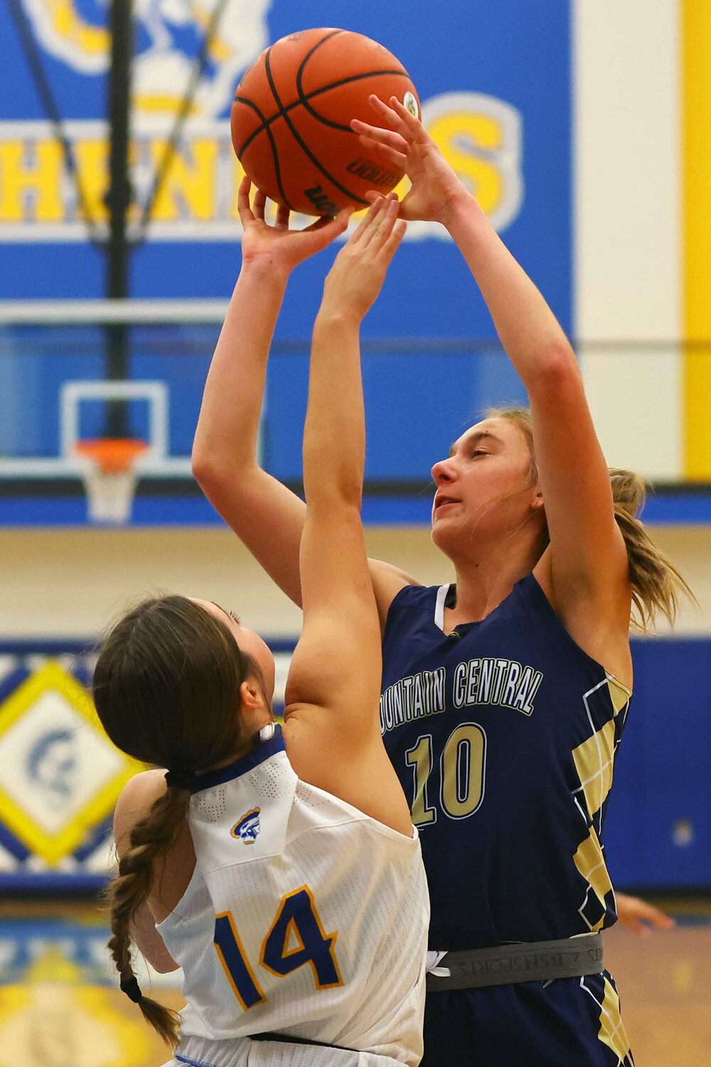 Brailey Hoagland of Fountain Central shoots over Aubrey Lowe of Crawfordsville.