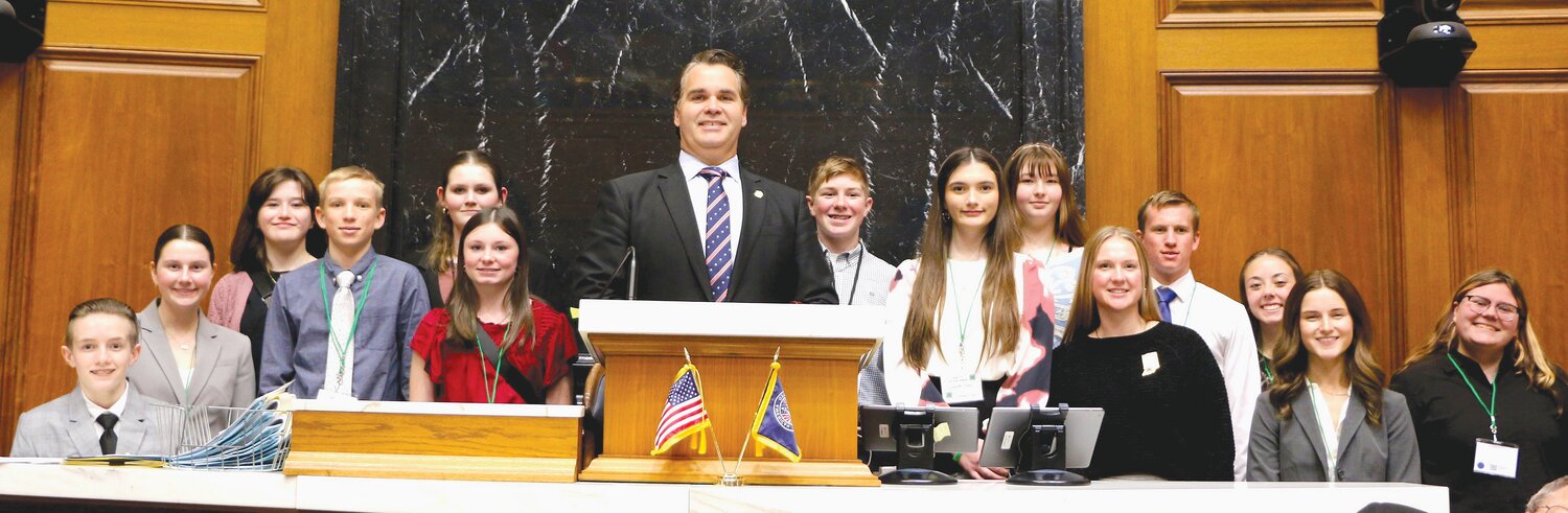 State Rep. Beau Baird (R-Greencastle), center, joins members of Montgomery County 4-H in the House Chamber for 4-H Day on Tuesday at the Statehouse in Indianapolis. Baird authored HB 1660, which would provide students in FFA and 4-H with excused absences from school.