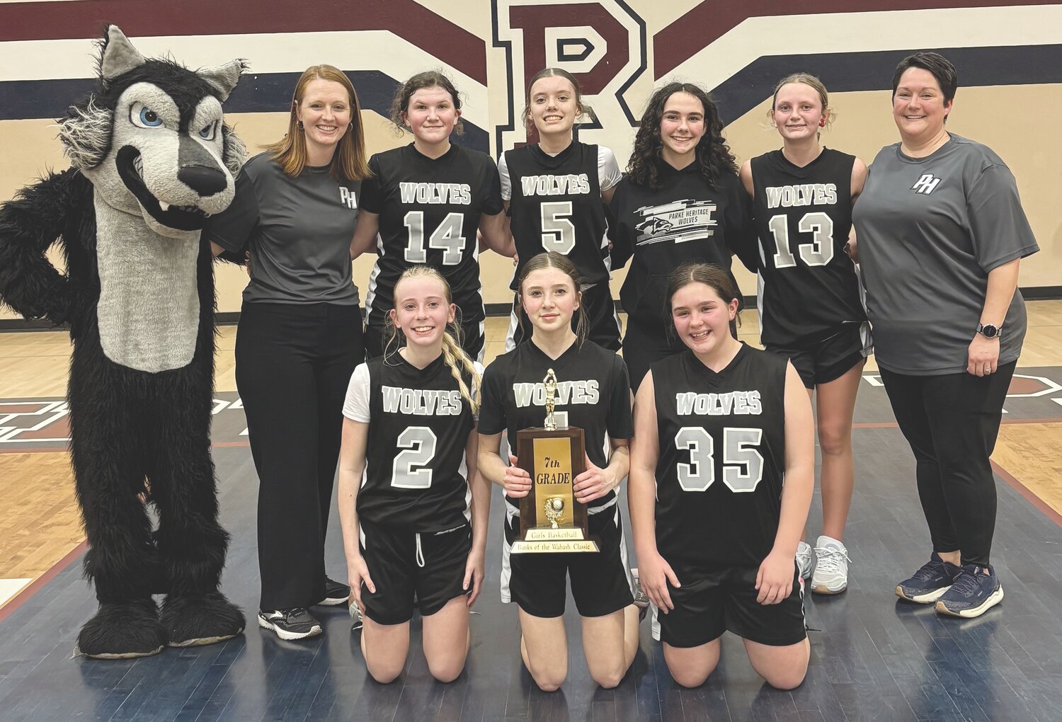 The Parke Heritage Middle School seventh grade girls basketball team won the Banks of the Wabash tournament on  March 12. Members of the seventh grade team are, from left, front row, Madi Schaefer, Breeann DeSmith, and Teagan Pound; and back row,  Wolfie (Cole McVay), Coach Elise Mauntel, Katy Faust, Hana Stonebraker, Vinny Bonomo, Lainey Bryant and Coach Brittany Bonomo.