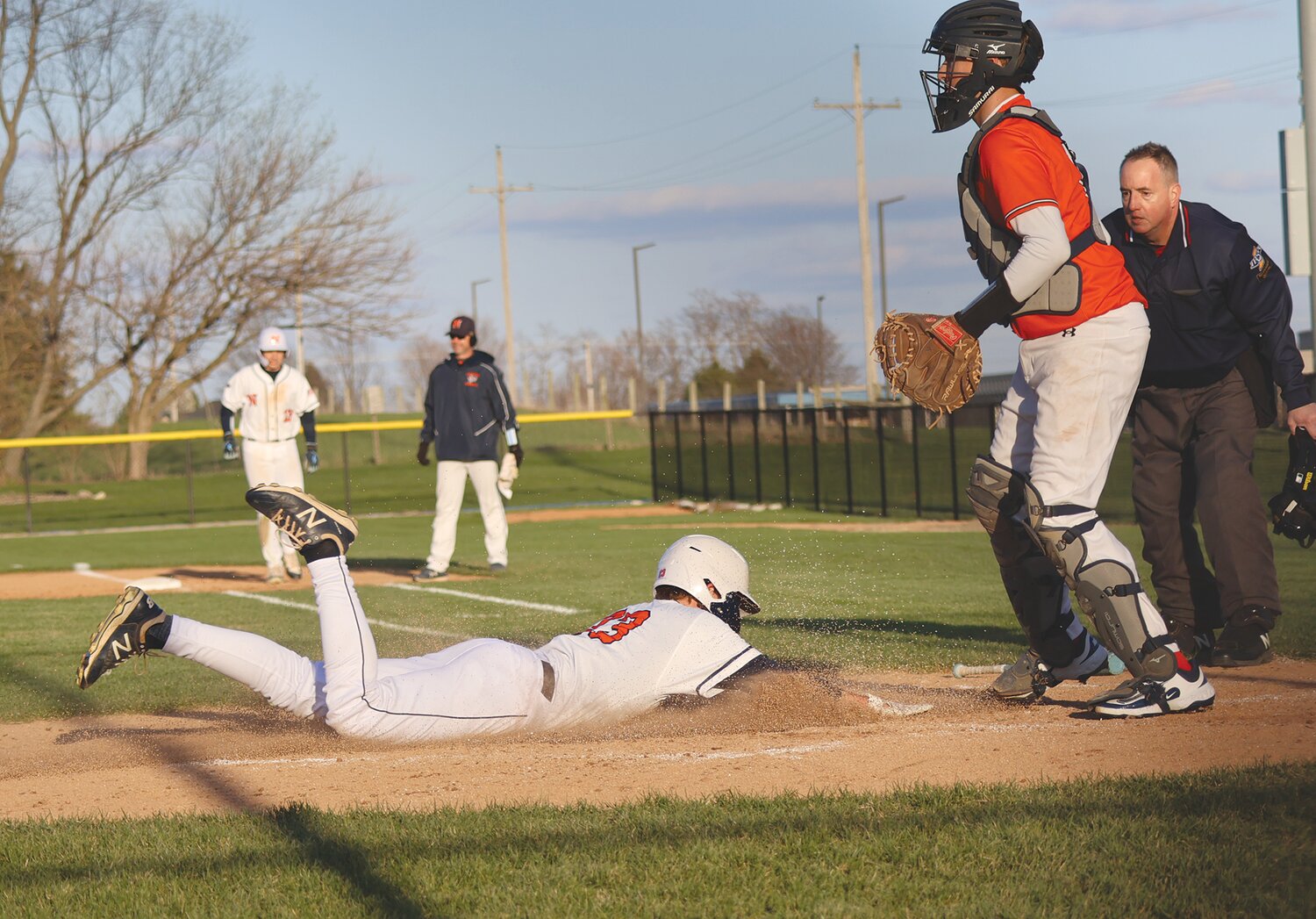 North Montgomery junior Crew Cole slides safely into home in the Chargers’ 7-3 win against North Putnam on Tuesday.
