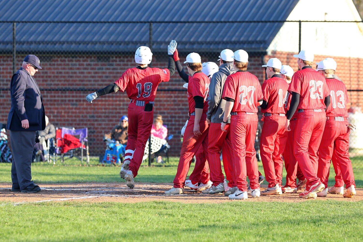 Dean McGaughey of Southmont was greeted at home after a three-turn home run.