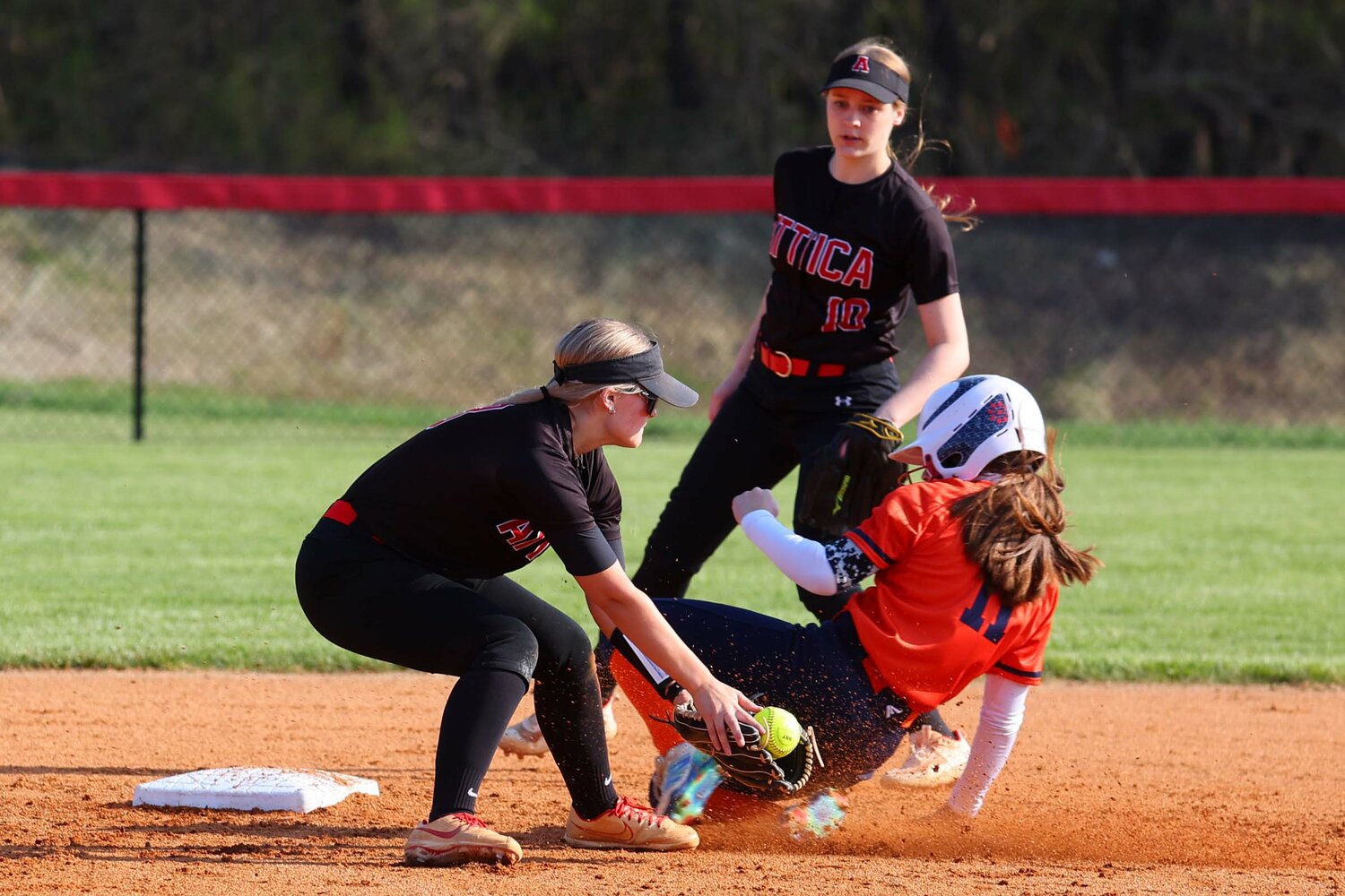 Bailey Nichols of North Montgomery - beating a throw to second base where Katelynn Driver of Attica tries for the tag