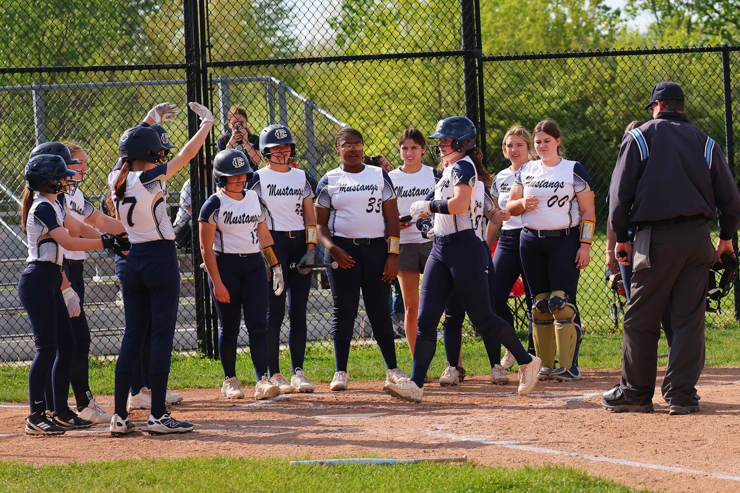 Jackie Weber of Fountain Central gets a greeting by her teammates after a home run.