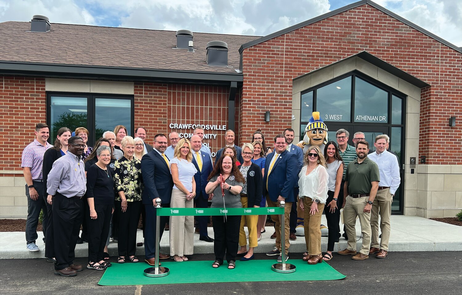 Crawfordsville Community School Corporation administrators, staff, board of school trustees, project partners and representative from the Crawfordsville-Montgomery County Chamber of Commerce gather Tuesday to cut the ceremonial ribbon at the newly constructed administration building. The new building at 3 Athenian Drive is located on the south side of the athletic parking lot at Crawfordsville High School. The 6,200 square foot building provides office space for the superintendent, assistant superintendent, curriculum director, food service director, accounting and payroll, the corporation treasurer and receptionist. Additionally, the building includes a lobby, board room, large conference room, kitchenette and storage space. Kettelhut Construction of Lafayette was awarded the contract for the $3.8 million project, which began in April of 2024.