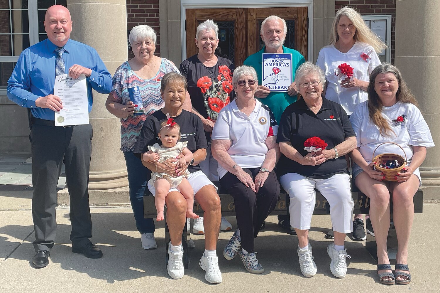 National Poppy Day will be celebrated this year on Friday. On this day, members of the American Legion Auxiliary will have a table set up outside of The Breakfast Company from 8 a.m. to 2 p.m. and a table set up outside Fusion 54 from 8 a.m. to 5 p.m. distributing poppies and accepting donations. Money collected from the poppies goes to help pay for a service dog for a veteran and toward a $500 donation to the Service Flight program. The auxiliary also puts together holiday gift bags for the veterans who reside in area nursing homes. They also help at the Veterans Home in Lafayette. All donations are appreciated. Pictured, from left, are Carol Roberts (holding Freya Smith), Bonita Clement, Rosemary Hutchison and Jackie Baldwin; and back row, Mayor Todd Barton (holding the city proclamation), Judy Mills, Cindy Biddle, Gary Baldwin and Carman Wethington.