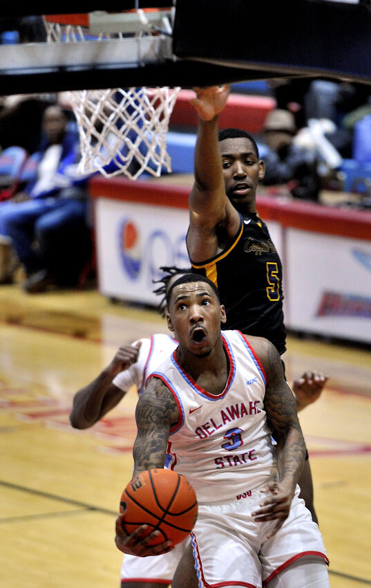 Delaware State's Martaz Robinson goes in for an underhand layup against Coppin State on Saturday.  SPECIAL TO THE DAILY STATE NEWS/GARY EMEIGH