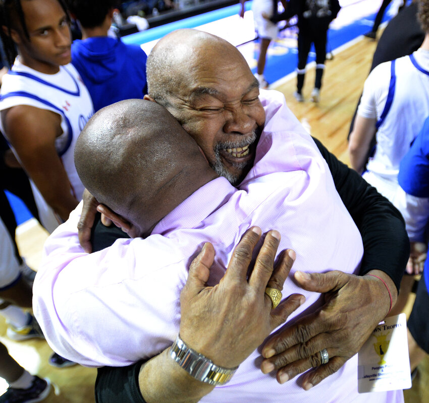 Dover High coach Stephen Wilson hugs his dad, Charles, as they celebrate the Senators' state championship win over Salesianum on Saturday night.  SPECIAL TO THE DAILY STATE NEWS/GARY EMEIGH
