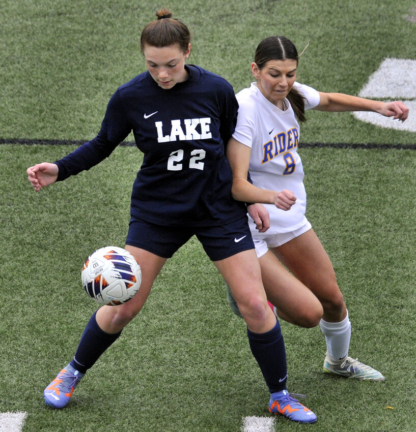 Lillian Wood of the Spartans blocks CR’s Kate Benson from the ball in first half of match played Thursday at Lake Forest.  SPECIAL TO THE DAILY STATE NEWS/GARY EMEIGH
