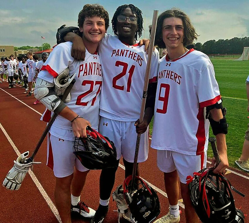 Alex Szell (27) with fellow Polytech lacrosse seniors Cameron Wilkerson (21) and Tyler Polisano (9). SUBMITTED PHOTO.