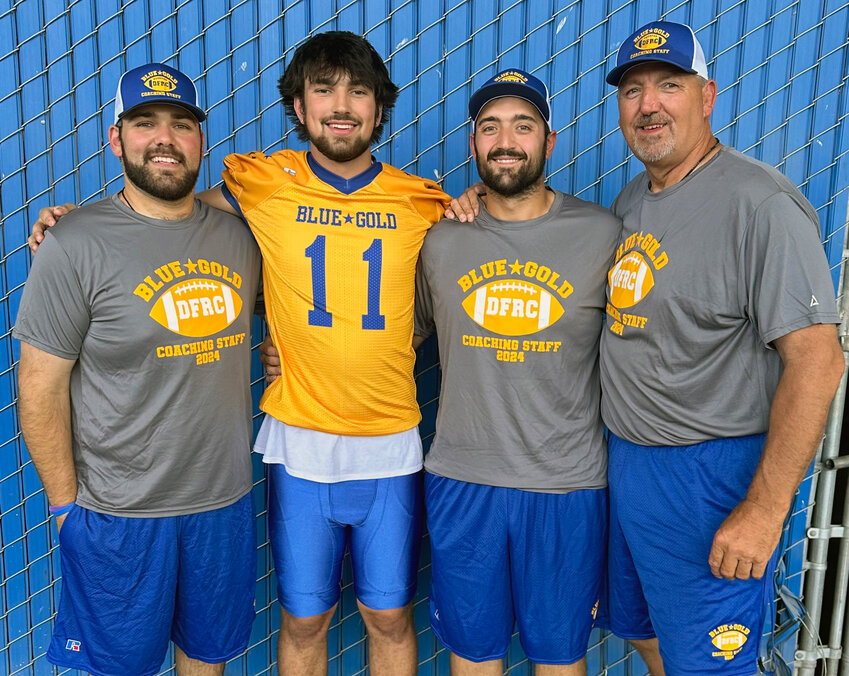 Smyrna High quarterback Jacob Tiberi with Blue coaching staff members Dom Trotta (left) and Brandon and Marvin Dooley. Tortta and Brandon Dooley were on the Blue team when Marvin coached in 2016 and now are on the Gold coaching staff. Both are graduates of William Penn. SUBMITTED PHOTO.